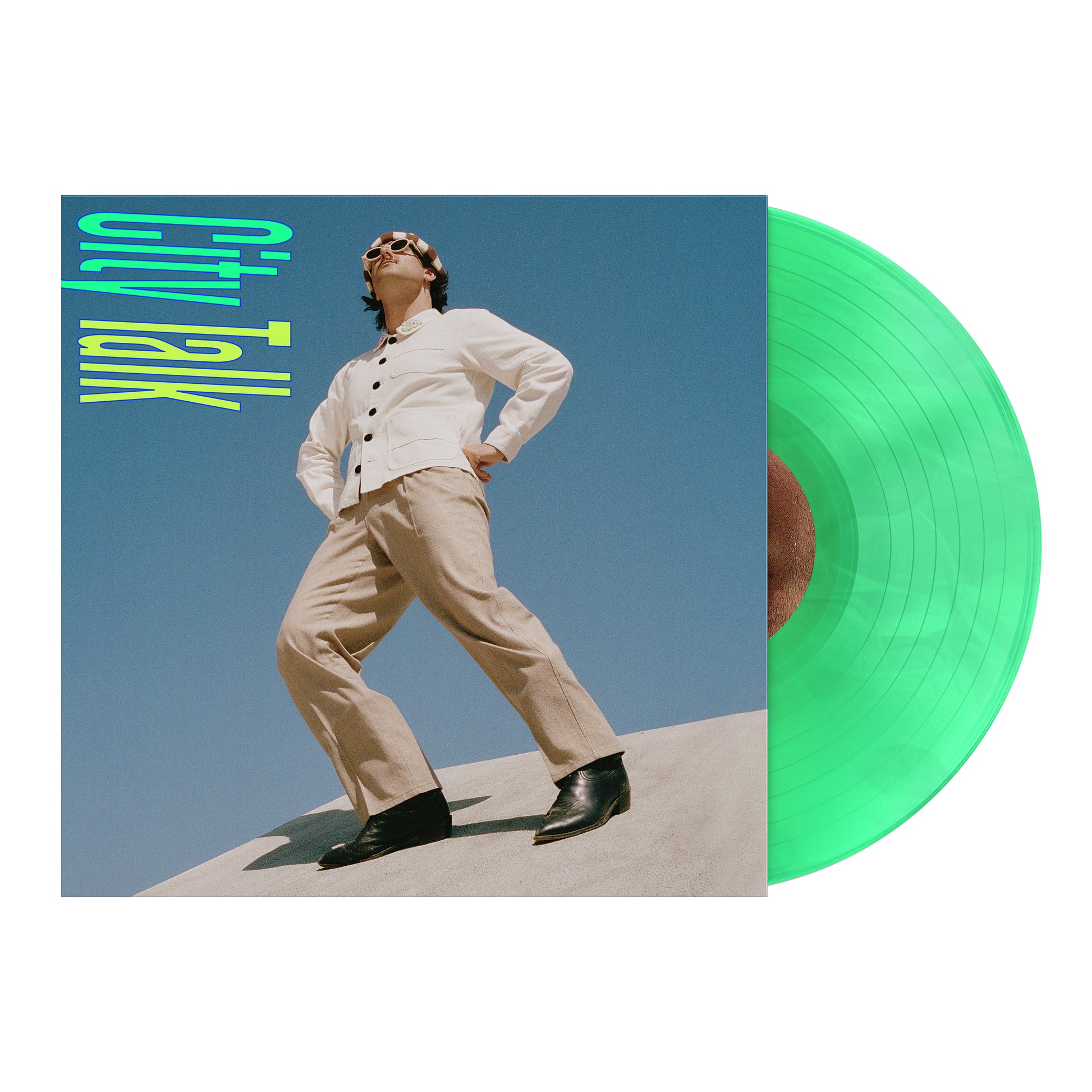 A green vinyl record by Halfnoise is partially in its sleeve, revealing an album cover of a person standing under a blue sky. The colorful text reads GTV Talk—preorder the vinyl before its November 17th release.