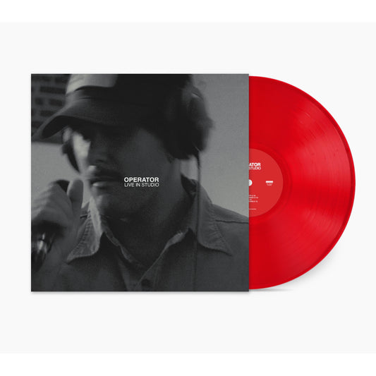 A translucent red vinyl record by Zac Farro partially slides out of its sleeve, which features a black-and-white photo of a person singing at Jewel Street Studios. The cover reads, OPERATOR LIVE IN STUDIO.
