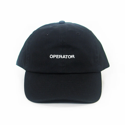 A black cotton chino twill dad hat by Zac Farro, featuring "OPERATOR" embroidered in white uppercase letters on the front, displayed against a plain white background.