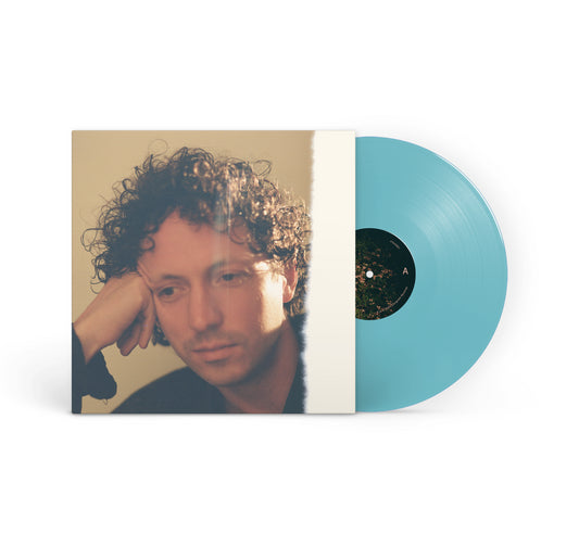A turquoise vinyl record from Congrats Records for Day Off partially slides out of its sleeve, which shows a man with curly hair resting his head on his hand and gazing thoughtfully downward.
